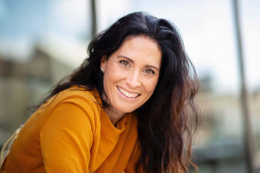 Portrait of beautiful caucasian woman smiling outdoors